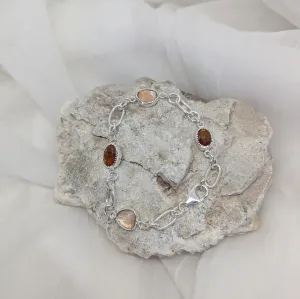 Silver bracelet with orange kyanite and topaz
